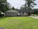 Charming single-story brick home featuring a covered carport and a well-maintained front lawn at 3929 Rockey Valley Dr, Conley, GA 30288