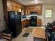 Cozy kitchen with wooden cabinets, black appliances, and functional layout at 3929 Rockey Valley Dr, Conley, GA 30288