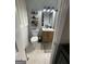 Charming bathroom with tile flooring, modern sink, and decorative wall shelves at 276 Colewood Nw Way, Atlanta, GA 30328