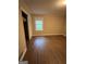 This bedroom features hardwood floors, a window that provides natural light, and a closet for storage at 276 Colewood Nw Way, Atlanta, GA 30328
