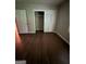 The bedroom has hardwood floors and a closet with sliding doors for storage at 276 Colewood Nw Way, Atlanta, GA 30328