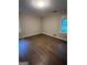 This bedroom has hardwood floors and a window that allows natural light to enter at 276 Colewood Nw Way, Atlanta, GA 30328