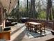 Wooden deck with dining and seating area, overlooking a green backyard at 276 Colewood Nw Way, Atlanta, GA 30328