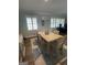 Dining room with a large wooden table, shuttered windows, and hardwood floors at 276 Colewood Nw Way, Atlanta, GA 30328