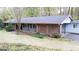 Ranch style home with mature trees, brick facade, and a well-maintained lawn at 276 Colewood Nw Way, Atlanta, GA 30328