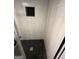 Modern shower with pebble floor, glass door, and white tile walls at 276 Colewood Nw Way, Atlanta, GA 30328