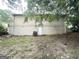 The backyard features a walkout basement door and a patio on the upper floor surrounded by mature trees at 3645 Croft Nw Pl, Atlanta, GA 30331