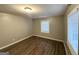 Bright bedroom featuring wood floors, a window providing natural light, and neutral walls at 3645 Croft Nw Pl, Atlanta, GA 30331