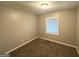 Cozy bedroom with neutral walls, plush carpeting, and a bright window with blinds at 3645 Croft Nw Pl, Atlanta, GA 30331