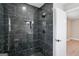 Luxurious bathroom featuring modern design and black marble tiles throughout the shower at 1515 Jonesboro Se Rd, Atlanta, GA 30315