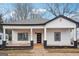 Charming renovated single-story home with white siding, black trim, and a welcoming front porch at 1515 Jonesboro Se Rd, Atlanta, GA 30315