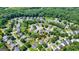 Neighborhood aerial view showcases many homes surrounded by mature trees, and maintained green spaces at 6665 Flagstone Ct # 918, Cumming, GA 30028