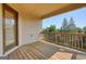 Covered back deck with wood flooring, railing, and a view of mature trees at 6665 Flagstone Ct # 918, Cumming, GA 30028