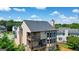 Back exterior features a multi-level deck, a wall of windows, and a beautifully maintained lawn at 6665 Flagstone Ct # 918, Cumming, GA 30028