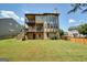 Large, grassy backyard with a two-story home and wooden deck at 6665 Flagstone Ct # 918, Cumming, GA 30028