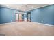 Large finished basement with plush carpet and blue walls at 6665 Flagstone Ct # 918, Cumming, GA 30028