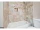 Bathtub with decorative tile surround in updated bathroom at 6665 Flagstone Ct # 918, Cumming, GA 30028