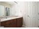 Bathroom featuring a double sink vanity with granite counters and wood cabinets at 6665 Flagstone Ct # 918, Cumming, GA 30028