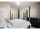 Bedroom with French doors, neutral walls, black furniture, and a cozy comforter at 6665 Flagstone Ct # 918, Cumming, GA 30028
