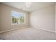 Bright bedroom features a large window with natural light and neutral carpet at 6665 Flagstone Ct # 918, Cumming, GA 30028
