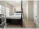 Bedroom with a four-poster bed, neutral colors, and access to the attached bath at 6665 Flagstone Ct # 918, Cumming, GA 30028