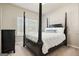 Bedroom features a four-poster bed, natural light, and a neutral color palette at 6665 Flagstone Ct # 918, Cumming, GA 30028