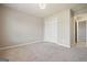 Bedroom features neutral carpet, white trim and bright lighting at 6665 Flagstone Ct # 918, Cumming, GA 30028