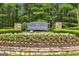 Elegant stone and floral landscaping mark the entry to the Parkstone community at 6665 Flagstone Ct # 918, Cumming, GA 30028
