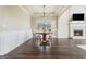 Cozy dining room with a modern chandelier, fireplace, and elegant furnishings at 6665 Flagstone Ct # 918, Cumming, GA 30028