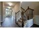 Spacious foyer with hardwood floors, staircase with detailed railings, and a view into the living area at 6665 Flagstone Ct # 918, Cumming, GA 30028
