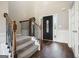 Elegant foyer with hardwood floors, staircase with iron railings, and a decorative front door at 6665 Flagstone Ct # 918, Cumming, GA 30028