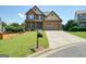 Beautiful two-story brick home with a well-manicured lawn and a two-car garage at 6665 Flagstone Ct # 918, Cumming, GA 30028