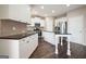 Well-lit kitchen features white cabinets, stainless steel appliances, and dark countertops at 6665 Flagstone Ct # 918, Cumming, GA 30028
