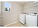 Laundry room with front-loading washer and dryer, tile flooring, and wire shelving at 6665 Flagstone Ct # 918, Cumming, GA 30028