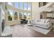 Inviting living room with soaring windows, a fireplace, and comfortable seating on a rug at 6665 Flagstone Ct # 918, Cumming, GA 30028