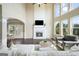 Bright living room features a soaring ceiling, fireplace with television, and large windows for natural light at 6665 Flagstone Ct # 918, Cumming, GA 30028