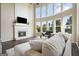 Bright living room featuring soaring windows, a fireplace, and comfortable seating at 6665 Flagstone Ct # 918, Cumming, GA 30028