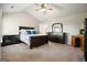 Main bedroom with high ceilings, plush carpet, fan, and dark wood furniture set at 6665 Flagstone Ct # 918, Cumming, GA 30028