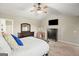 Bright main bedroom features a ceiling fan, carpet, TV, and dark wood furniture at 6665 Flagstone Ct # 918, Cumming, GA 30028