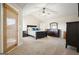 Main bedroom features a ceiling fan, neutral carpet, ample closet space, and dark wood furniture at 6665 Flagstone Ct # 918, Cumming, GA 30028