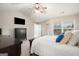 Bright main bedroom featuring a ceiling fan, large window, and dark wood furniture at 6665 Flagstone Ct # 918, Cumming, GA 30028