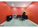 Bright office space with red walls, black desk, and gamer chair at 6665 Flagstone Ct # 918, Cumming, GA 30028