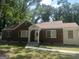Charming brick home with a classic design, inviting front porch, and lush green surroundings at 718 N Hairston Rd, Stone Mountain, GA 30083