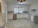 Bright kitchen with white cabinets, stainless steel appliances, and stone countertops at 718 N Hairston Rd, Stone Mountain, GA 30083