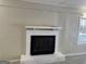 Living room featuring a white brick fireplace and plush carpeting at 718 N Hairston Rd, Stone Mountain, GA 30083