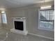 Spacious living room featuring a fireplace, new carpet and abundant natural light through many windows at 718 N Hairston Rd, Stone Mountain, GA 30083