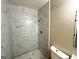 Bathroom with marble tile shower, modern fixtures, and a white toilet at 2644 Connally Dr, East Point, GA 30344