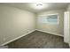Cozy bedroom featuring plush carpeting, neutral walls, and a bright window for natural light at 2644 Connally Dr, East Point, GA 30344