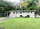 Charming brick home featuring a well-kept lawn, stylish shutters, and a vibrant red front door at 2644 Connally Dr, East Point, GA 30344
