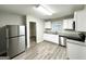 Modern kitchen with stainless steel appliances, white cabinets, granite countertops, and tile floors at 2644 Connally Dr, East Point, GA 30344